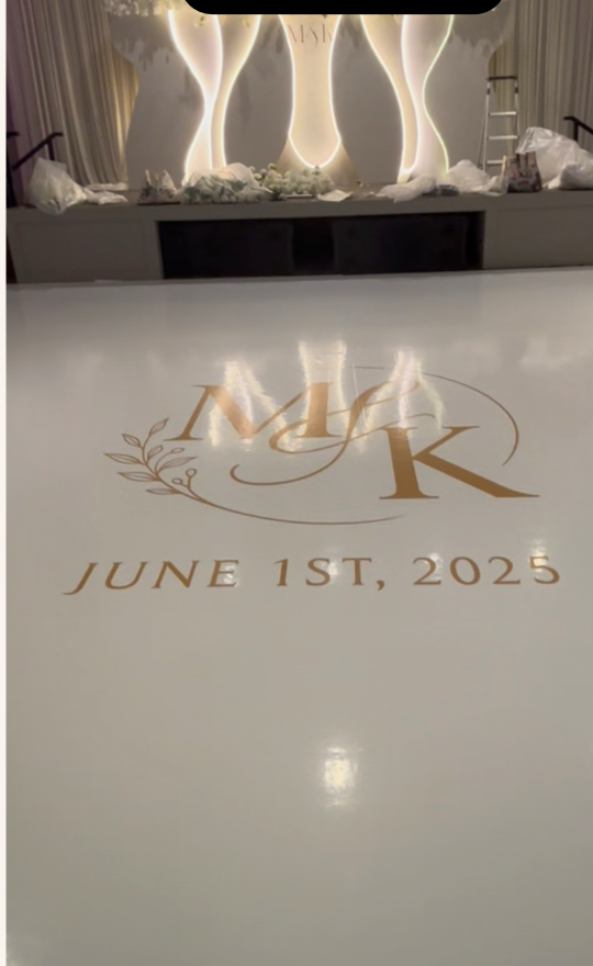 Same venue after — white floor wrap with gold M&K monogram